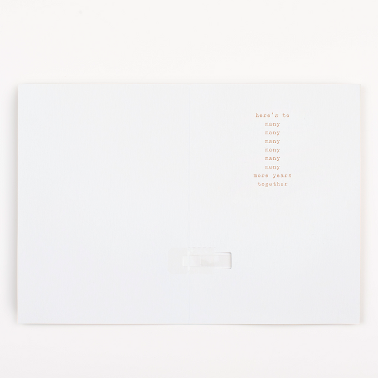 Inside of Joker Greeting endless musical anniversary card with here's to many many many many many many more years together message design