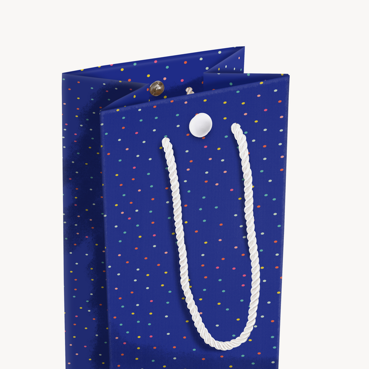 Opened endless birthday musical wine gift bag with royal blue background and colorful confetti dots from Joker Greeting collection