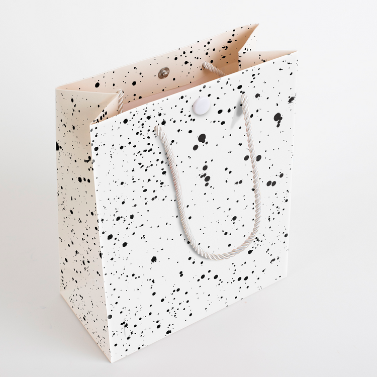 Side view of speckled endless scream musical gift bag showing sturdy construction and premium rope handle design