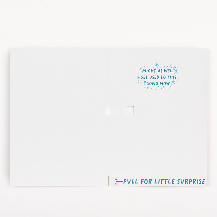 Inside of Joker Greeting endless musical baby shower card with might as well get used to this song now message and pull for little surprise tab; under the tab we hid glitter and stickers