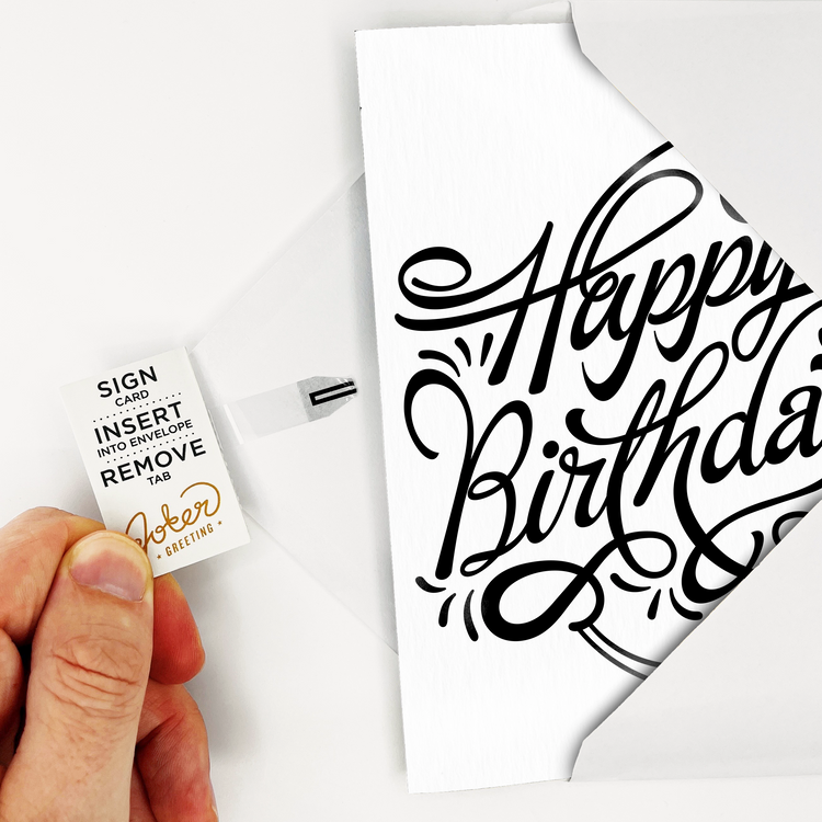 Card Front with Envelope – Elegant black and white Happy Birthday card with musical icon, tab visible, resting on white envelope.