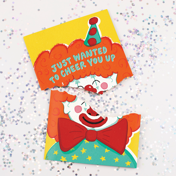 Endless musical cheer up card with cheerful clown design and large glitter scattered around broken card from Joker Greeting