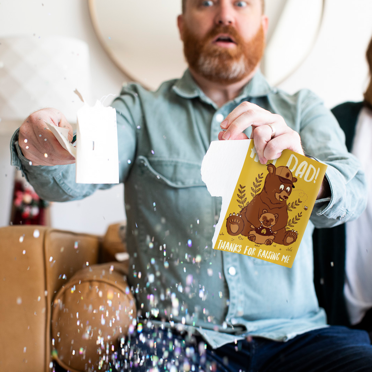 Man opening endless baby crying Father's Day prank card with glitter confetti - Hey Dad Thanks for Raising Me bear design musical greeting card