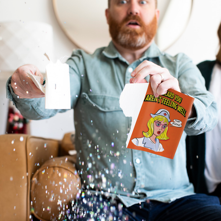 Man ripping the get well soon card apart.