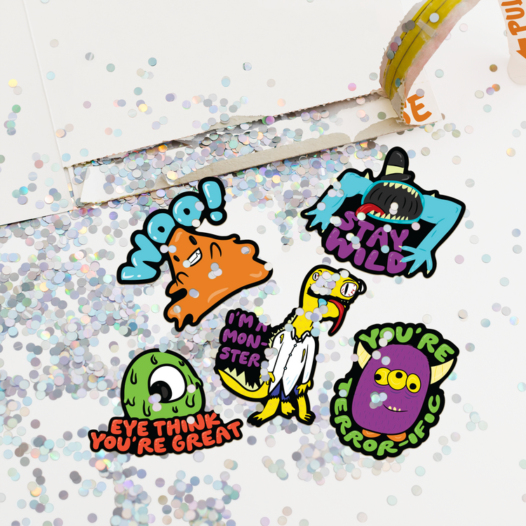 Open Halloween card with colorful glitter and spooky monster stickers including creatures with Stay Wild, Eye T