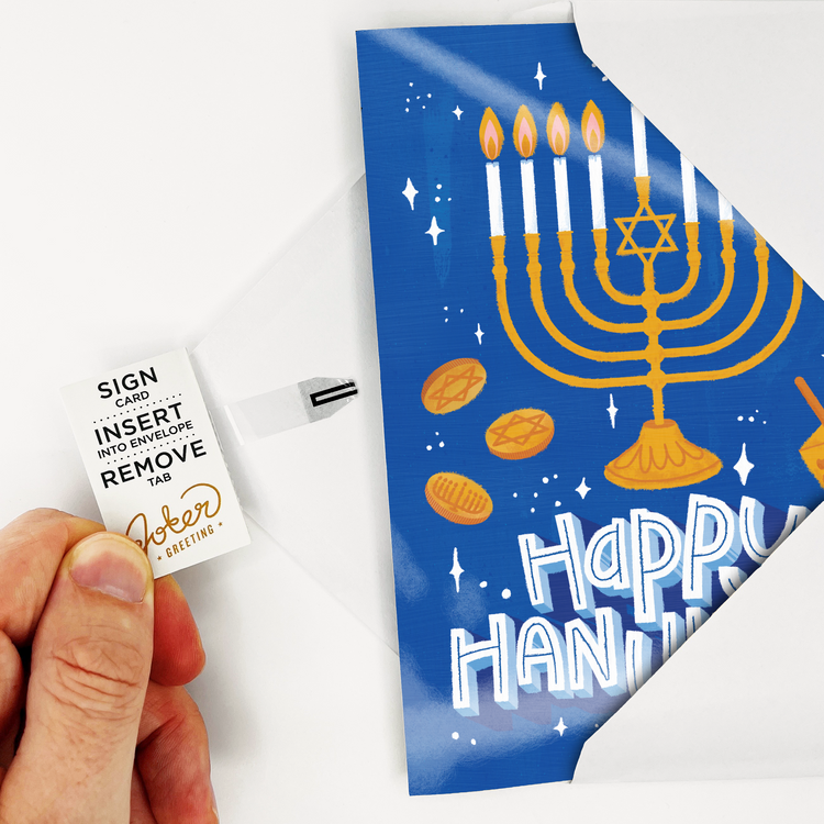 Person holding activated Joker Greeting Hanukkah card with Happy Hanukkah menorah design activating the card