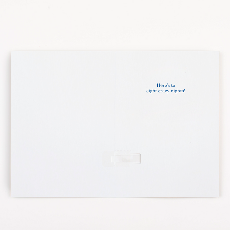 Hanukkah card opened showing here's to eight crazy nights message with Festival of Lights celebration theme