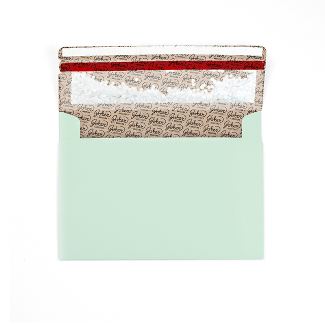 (Envelope with branded interior visible): Joker Greeting mint green glitter envelope showing interior branding and prank mechanism setup in calming mint color