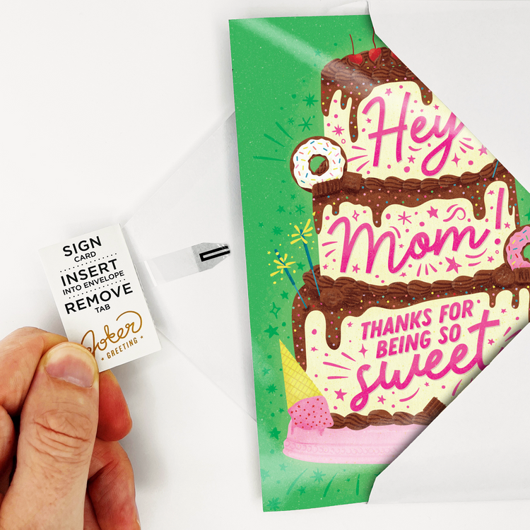 Hand pulling the tab out of the Baby Shark Mother's Day card activating the card