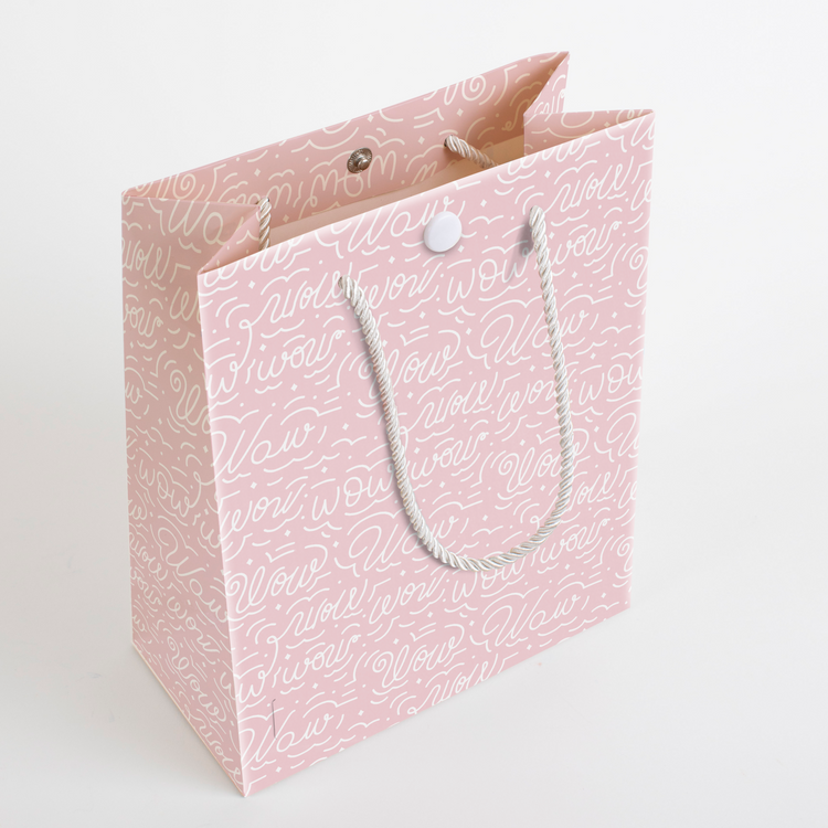 Pink musical gift bag with Wow (upside down Mom) pattern showing 3D structure and rope handles for endless Mom looping sound prank