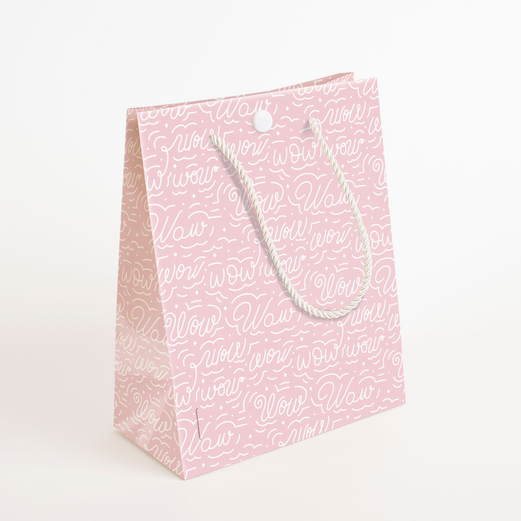 Side angle of endless Mom musical prank gift bag showing pink Wow design and rope handle construction