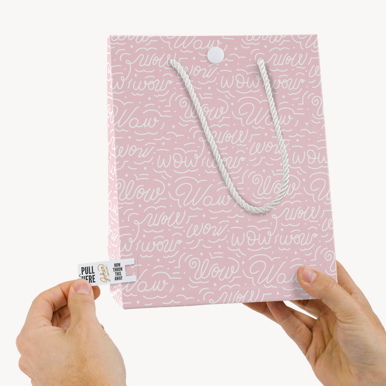 Hands holding Joker Greeting endless Mom musical gift bag with pink Wow pattern and pull tab activation system