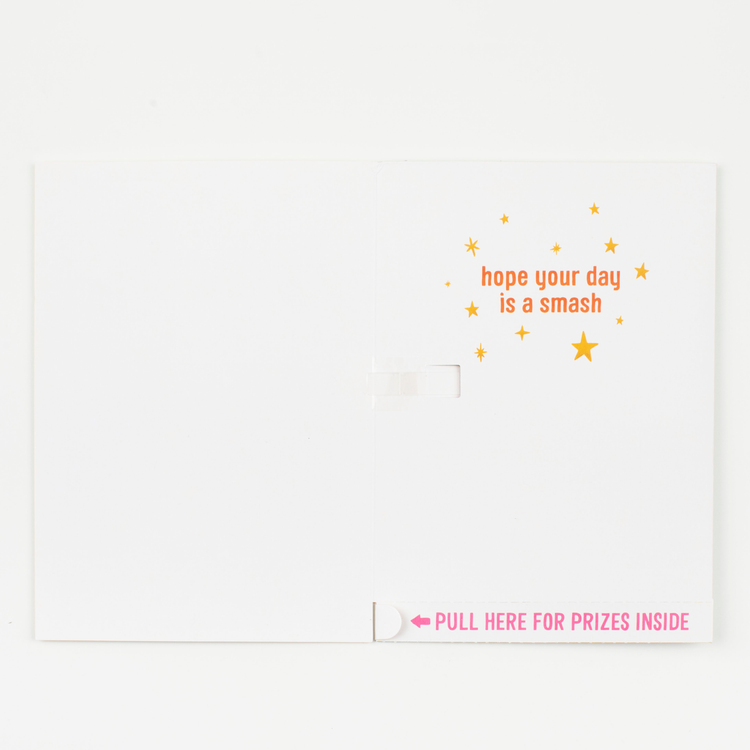 Inside Card Message:
Inside view of piñata birthday card showing Hope Your Day Is A Smash message with stars and Pull Here For Prizes Inside instruction strip