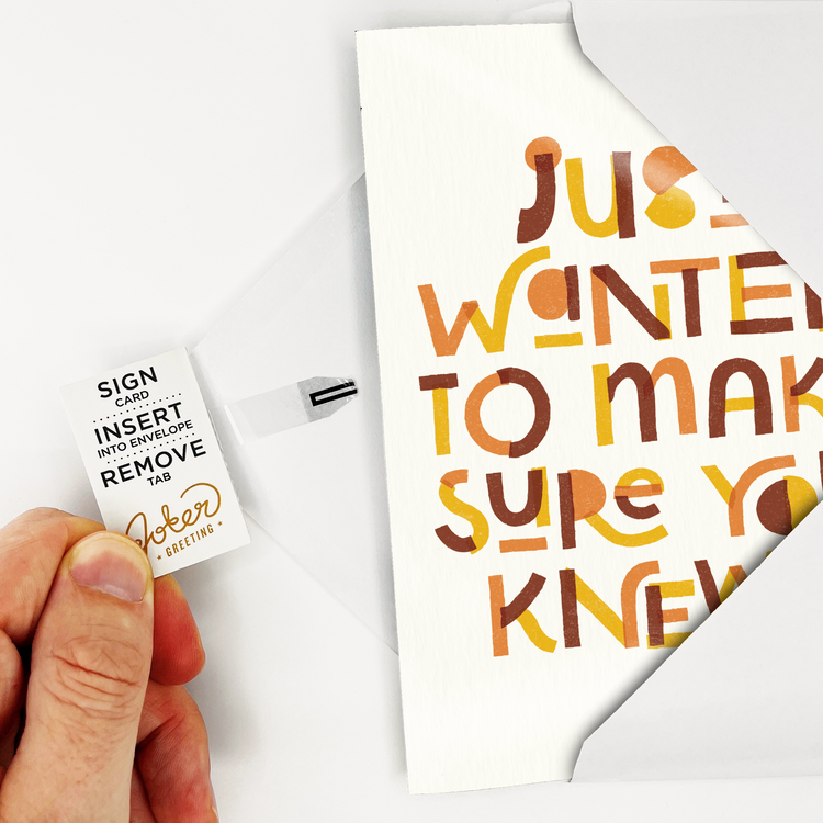 Hand holding tab removal system on endless GOAT musical card showing Joker Greeting branding and activation instructions