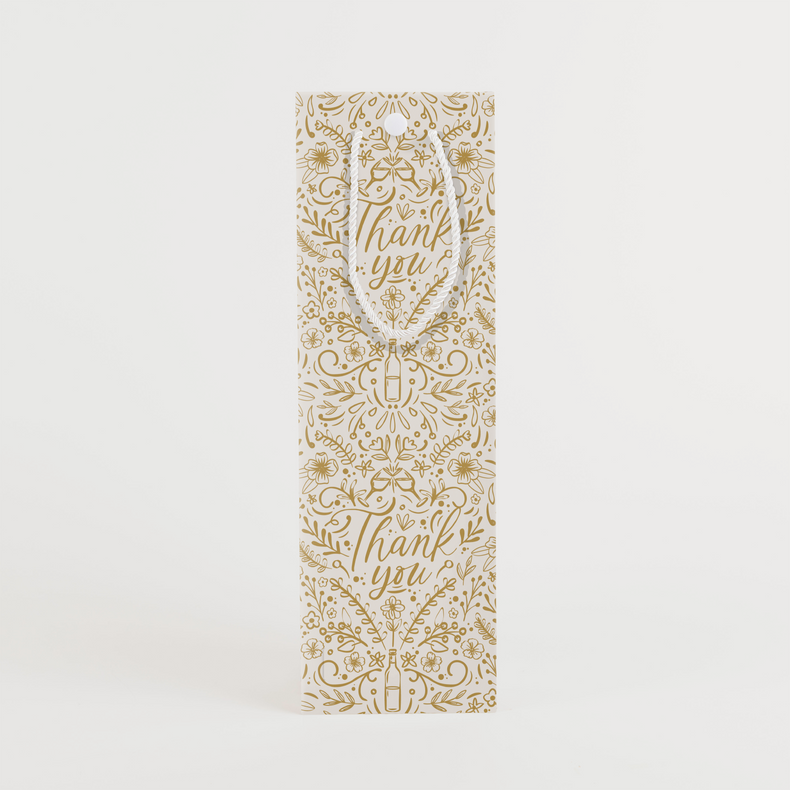 Front view of thank you wine gift bag with elegant gold botanical pattern and cursive thank you lettering on white background