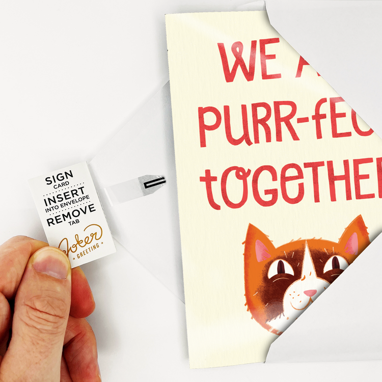 Hand pulling the tab from the spine of the card