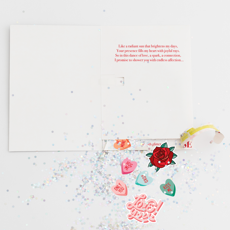 Opened Joker Greeting endless musical Valentine card showing large glitter and romantic heart stickers scattered around with love-themed designs "Hug Me," "Only You," "Kiss Me," and "Love You."