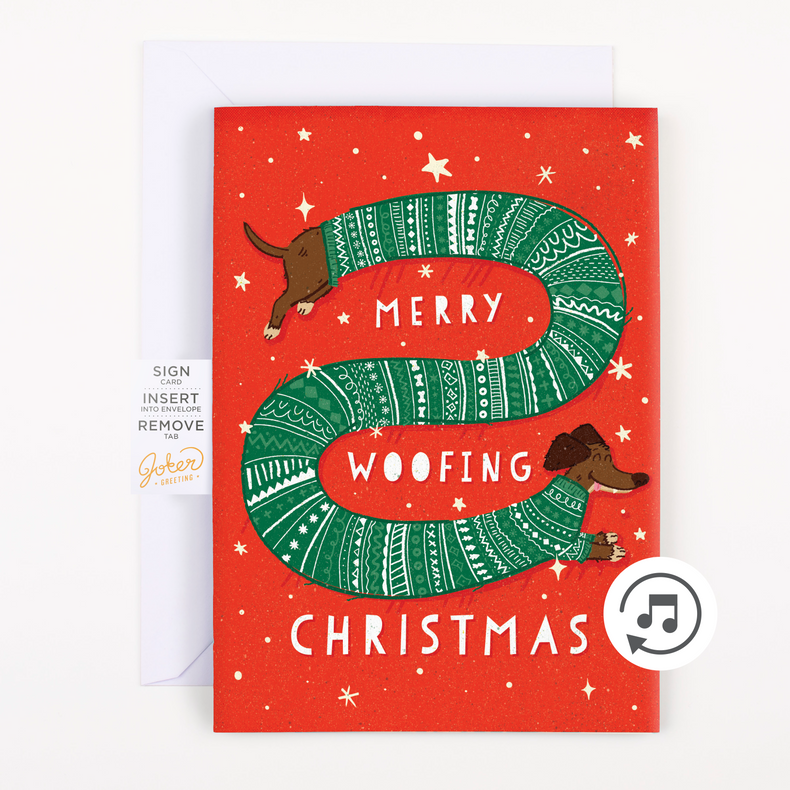 A Christmas themed greeting card with dogs and text 'Merry Woofing Christmas', with a red background and glitter embellishments.