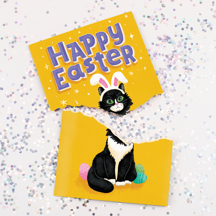 Musical Easter greeting card torn apart showing black cat with bunny ears design and large glitter scattered around Happy Easter message