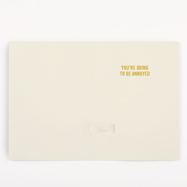 Inside view of endless fortune teller musical greeting card showing You're Going to Be Annoyed message in gold text on cream background