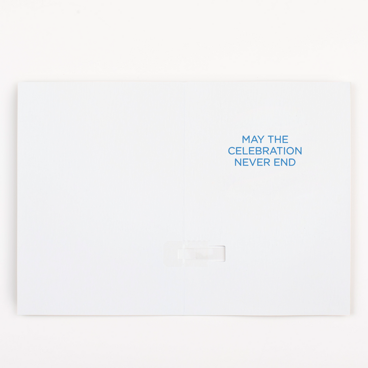Inside view of endless Macarena musical greeting card showing May the Celebration Never End message in blue text