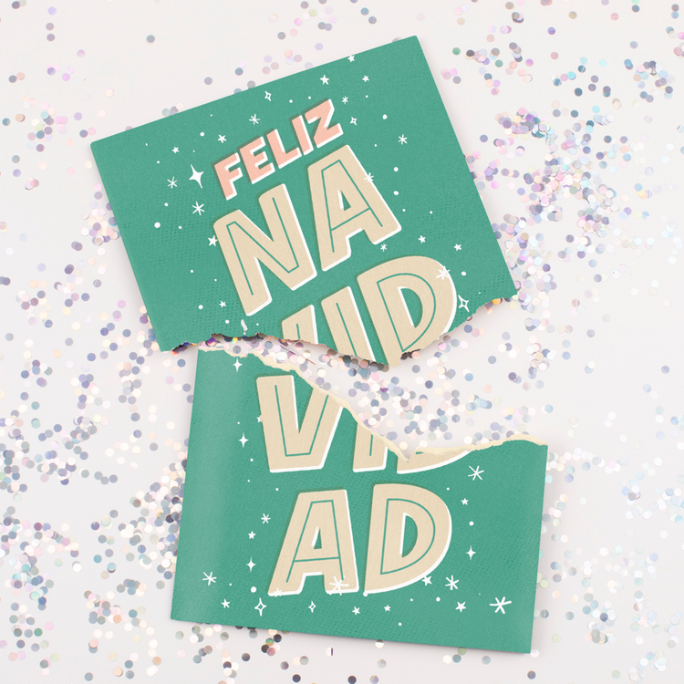 Torn Feliz Navidad musical card showing large colorful glitter spill demonstration of glitter