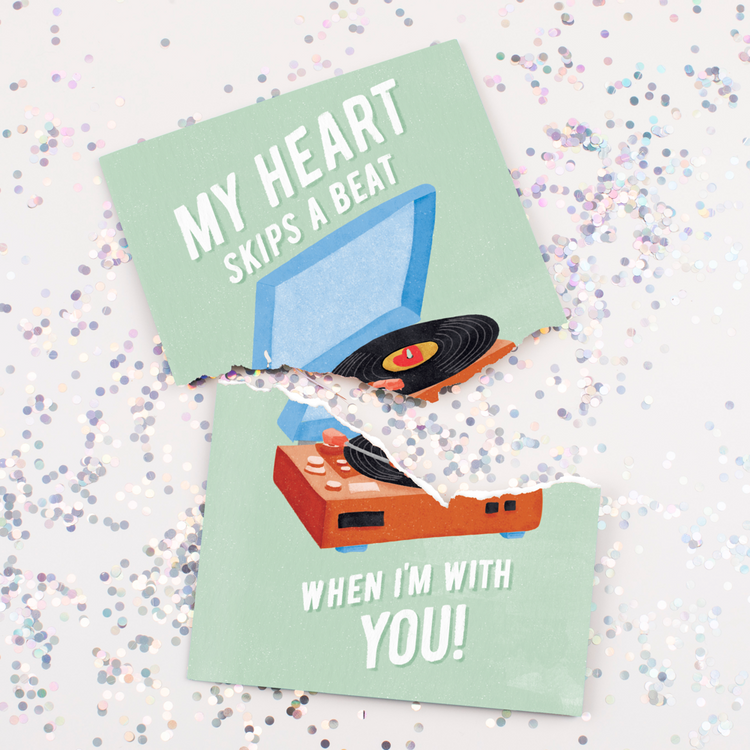 Torn musical Valentine's card featuring retro turntable record player design surrounded by colorful glitter confetti showing what happens when recipient tries to stop the music
