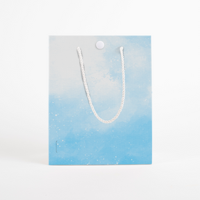 Blue gradient musical gift bag with white rope handles and button closure from Joker Greeting endless Baby Shark collection