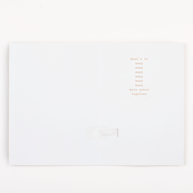 Inside of Joker Greeting endless musical anniversary card with here's to many many many many many many more years together message design