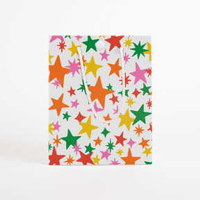 Colorful star-patterned musical gift bag with white rope handles and button closure from Joker Greeting endless mariachi collection