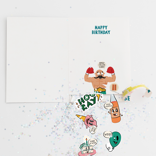 Open birthday card revealing HOORAY message with colorful glitter and character stickers including cake, balloon, and celebration designs
