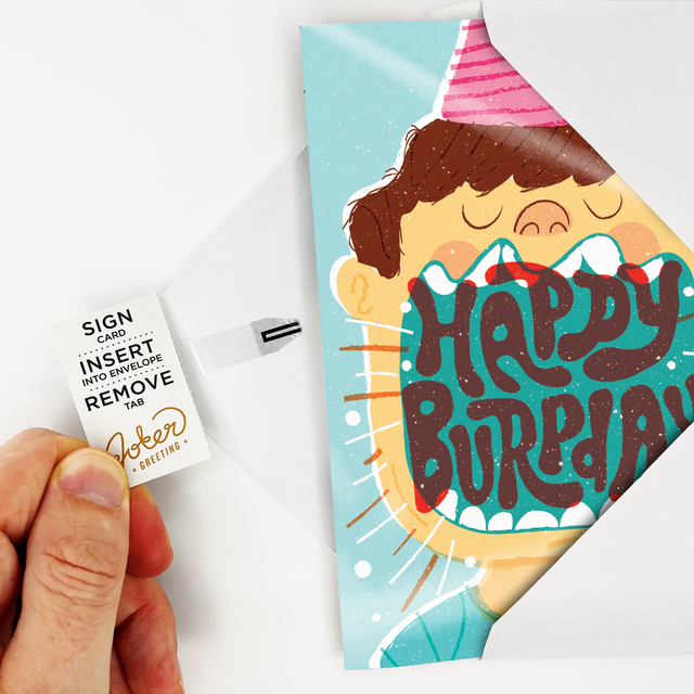 Card with Tab Demonstration:
Hand demonstrating Birthday Burp musical prank card with Joker Greeting instruction tab showing Sign Card Insert Into Envelope Remove Tab activation process
