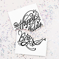 Glitter on Table – Joker Greeting birthday card ripped in half surrounded by silver glitter fallout.
