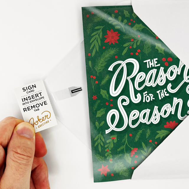 Joker Greeting endless Christmas musical card with green foliage design asking The Reason for the Season with pull tab mechanism