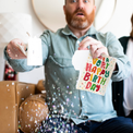 Man opening endless birthday fart card with glitter explosion - Have a Very Happy Birthday musical prank card plays fart sounds nonstop