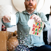 Man opening endless birthday fart card with glitter explosion - Have a Very Happy Birthday musical prank card plays fart sounds nonstop