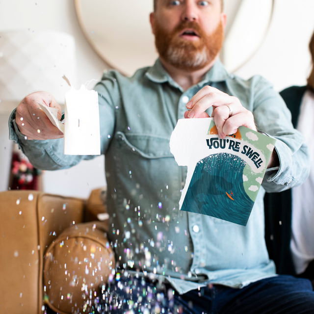 Lifestyle image of Father's Day Baby Shark card being torn apart after user gets tired of it looping nonstop. 