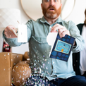  Person holding activated Joker Greeting graduation card with you did it message and large glitter falling showing endless musical prank in action
