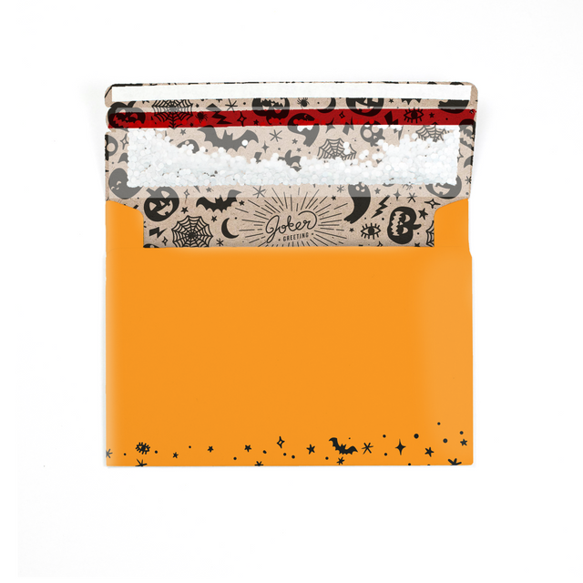 (Envelope with Halloween interior visible): Halloween orange glitter envelope showing spooky themed interior branding and prank mechanism setup
