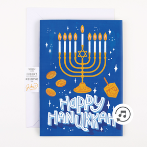 Joker Greeting Hanukkah card product packaging showing musical prank card with menorah and dreidel design and activation instructions with music note symbol
