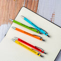 Close-up of workplace humor pen with that's not my job saying and clicking mechanism for office entertainment