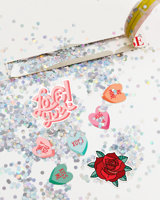 Colorful heart-shaped stickers with messages on a glittery background