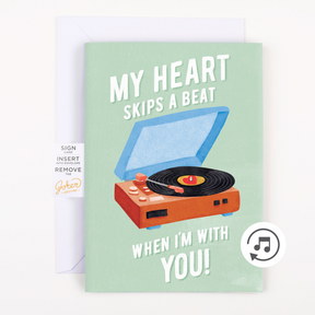 A greeting card with an illustration of a record player and the text 'MY HEART SKIPS A BEAT WHEN I'M WITH YOU!' and a musical note icon indicating the song loop feature.