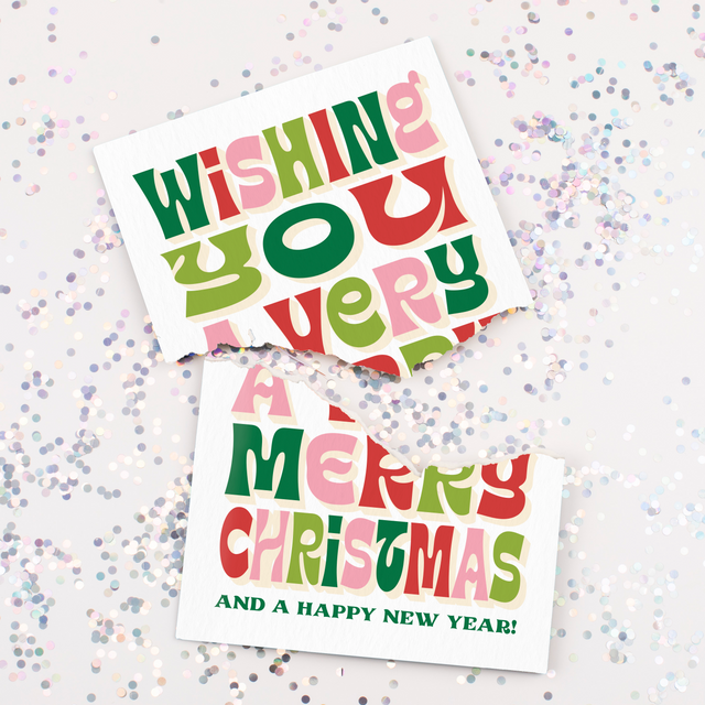 Colorful Christmas card with text on a glittery background. Card is ripped apart. 