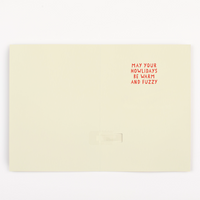  Inside of woofing Christmas card showing warm fuzzy holiday message before endless musical dog howling prank activates
