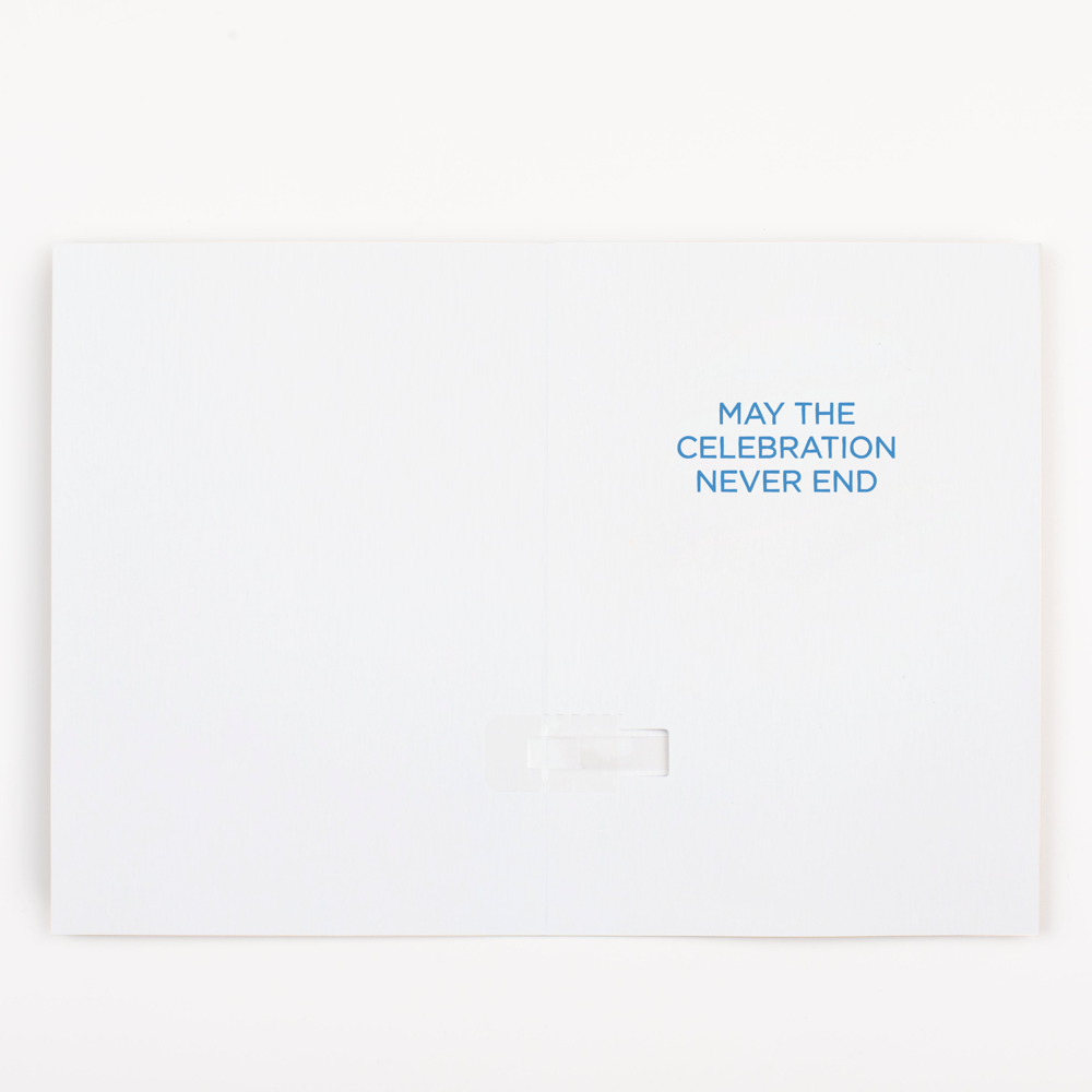 Inside view of endless Macarena musical greeting card showing May the Celebration Never End message in blue text
