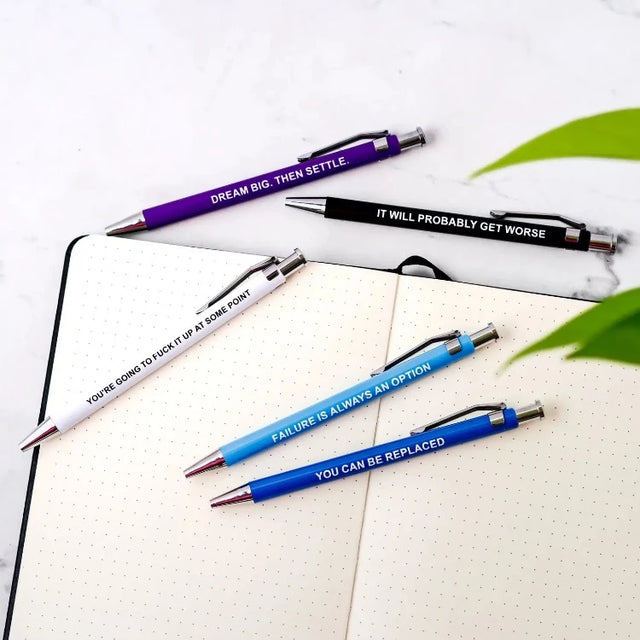 Close-up of demotivational pen with brutally honest workplace saying and clicking mechanism for office annoyance