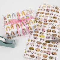 Double sided gift wrap paper. Rainbows on one side and boobs on the other side. 
